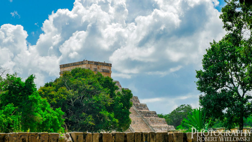 Chichen Itza pyramid tree line Distant view of Kukulcan EL Castillo hanging over the tree line. best ruins in mexico