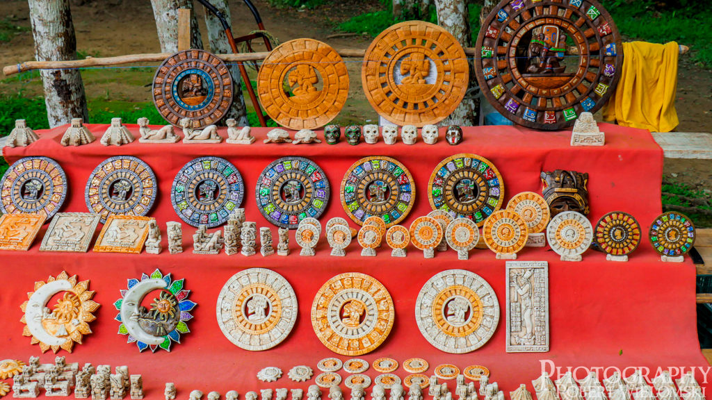 Various Maya Arts and Crafts displayed on a table made from cedar and fish bone.
